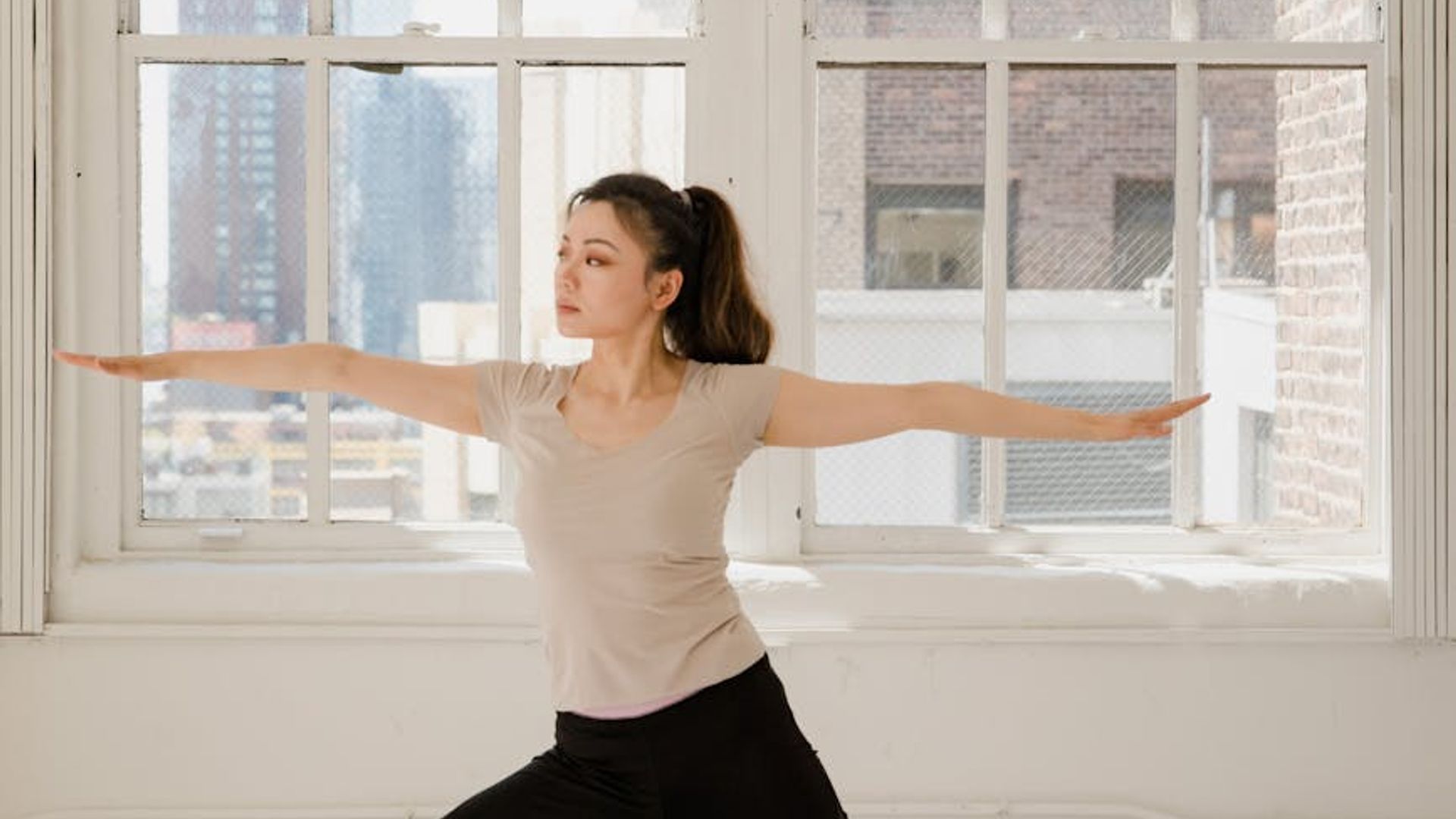 Calm and focused person in a fluid yoga movement.